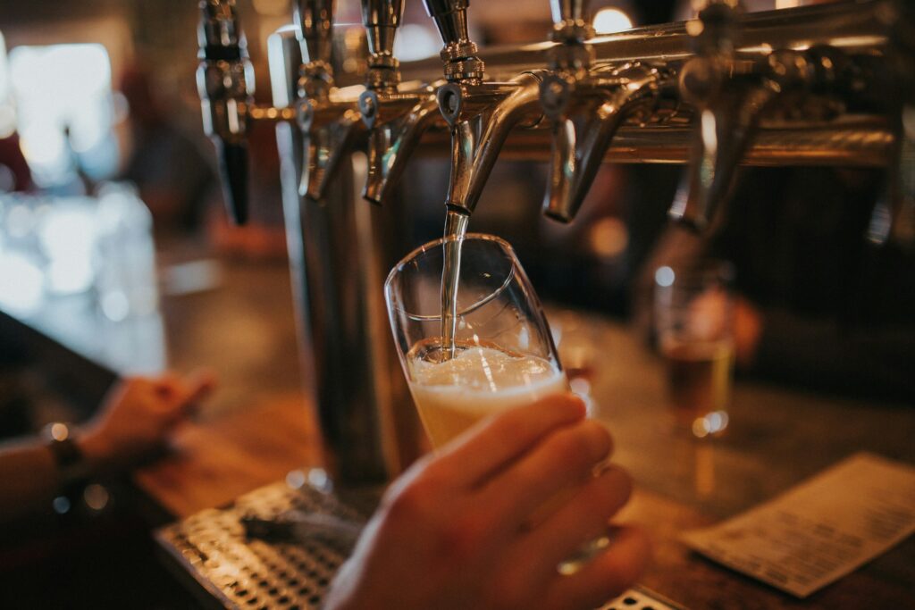 Hand pouring a pint of beer